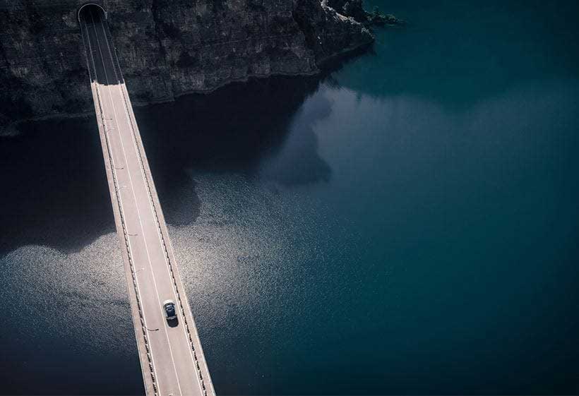 Volvo cars crossing a bridge (viewd from above)